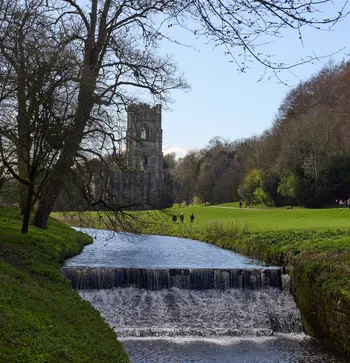 Looking towards Fountains abbey from the River Skell on a sunny spring day portrait.jpg